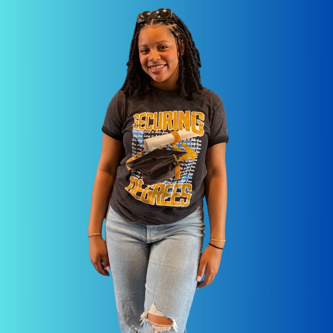 Student proudly wearing Securing Degrees scholarship support t-shirt to promote scholarship