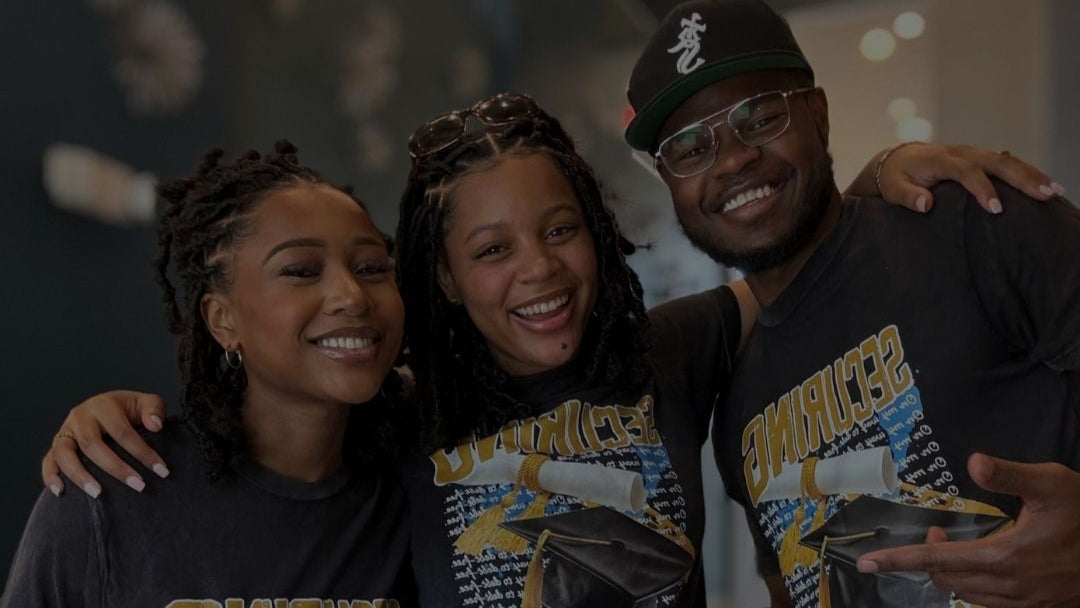 Students wearing matching scholarship support t-shirts celebrating success.
